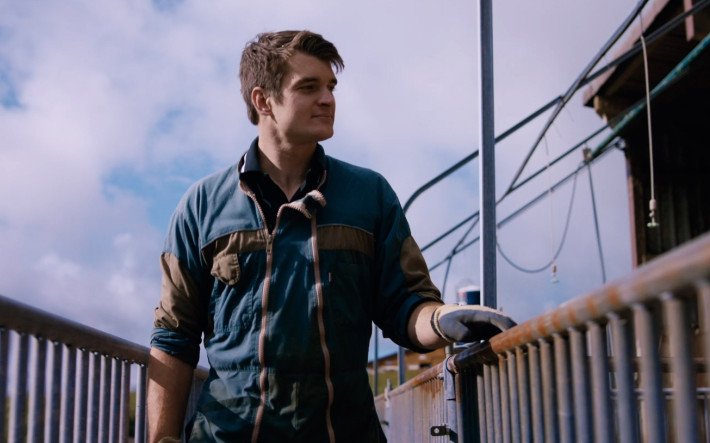 Man looking over fence