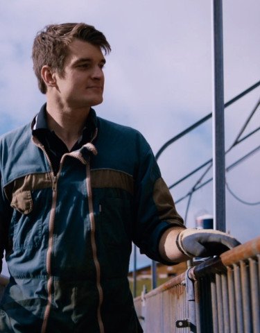 Man looking over fence