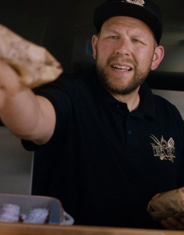 Cook handing over food
